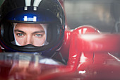 Close up race car driver in helmet looking away