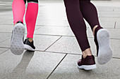 Close up feet of female runners jogging