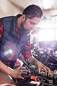 Male mechanic fixing motorcycle