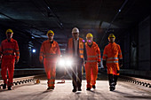Male foreman and construction workers walking