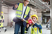 Male foreman and engineer with theodolite
