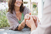 Close up mature couple holding hands