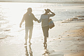 Mature couple holding hands and walking