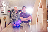 Portrait male carpenters making wood boat