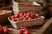Fresh, red vine cherry tomatoes in container