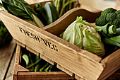 Fresh, green vegetables in wooden crate