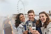 Friends toasting champagne, London, UK