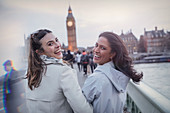 Women friends walking toward Big Ben, London, UK