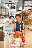 Portrait lesbian couple shopping in market