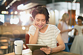 Young woman using tablet in cafe