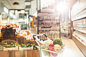 Fresh produce in shopping cart in market