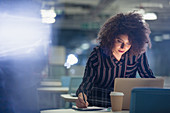 Focused businesswoman working late