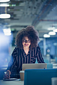 Portrait businesswoman working late at laptop