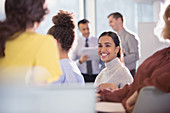 Smiling businesswoman talking to colleagues