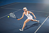 Young woman playing tennis on tennis court