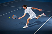 Male tennis player playing tennis