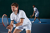 Focused tennis doubles players playing tennis