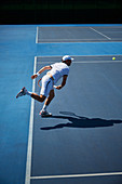 Male tennis player playing tennis