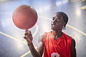 Young basketball player spinning basketball