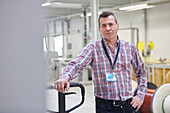 Portrait confident worker in fiber optics factory