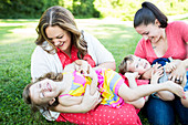 Playful lesbian mothers tickling children