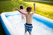 Preschool brother and sister playing and splashing