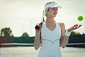 Smiling tennis player holding tennis racket