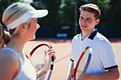 Male and tennis players talking