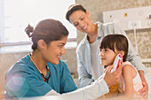 Female nurse using digital thermometer