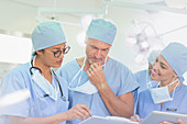 Surgeons reviewing paperwork