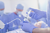 Anaesthesiologist injecting anaesthesia medicine