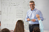 Smiling male science teacher leading lesson