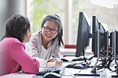Smiling girl students researching at computer