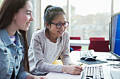 Girl students researching at computer