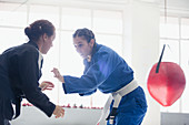 Women practicing jiu-jitsu in gym