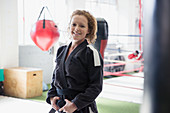 Portrait woman in jiu-jitsu uniform in gym