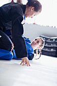 Determined, tough women practicing jiu-jitsu in gym