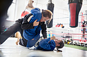 Women practicing jiu-jitsu in gym