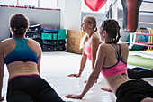 Young women stretching in dog yoga pose