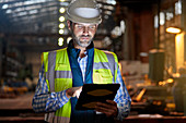 Male engineer working at glowing tablet