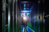 Male security guard walking in dark server room