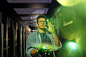 Male IT technician using futuristic tablet