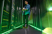 Male IT technician with glowing green panels
