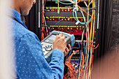 IT technician using fibre optic tester equipment