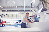 Mechanic engineers working in airplane cockpit
