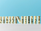Falling in domino in a row on blue background