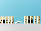Domino falling in a row on blue background