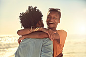 Laughing young couple hugging