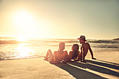 Young friends relaxing on idyllic, beach