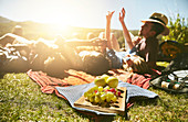 Young friends enjoying picnic in park